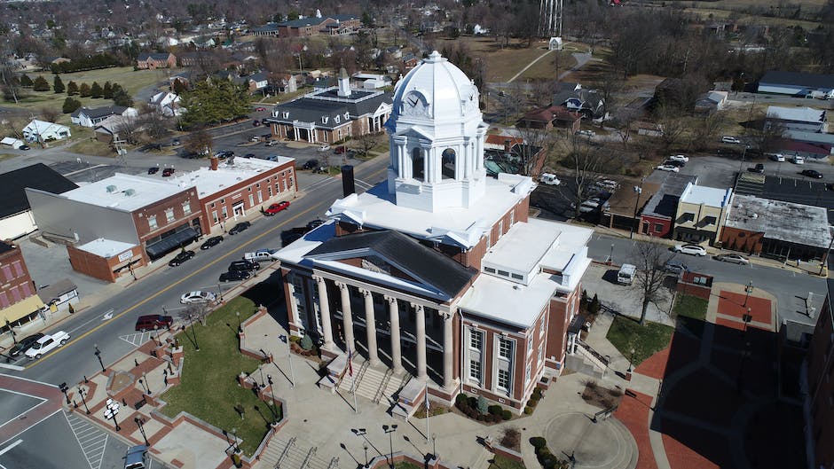 A person standing in front of a courthouse, symbolizing the importance of a DUI lawyer in defending oneself in court.