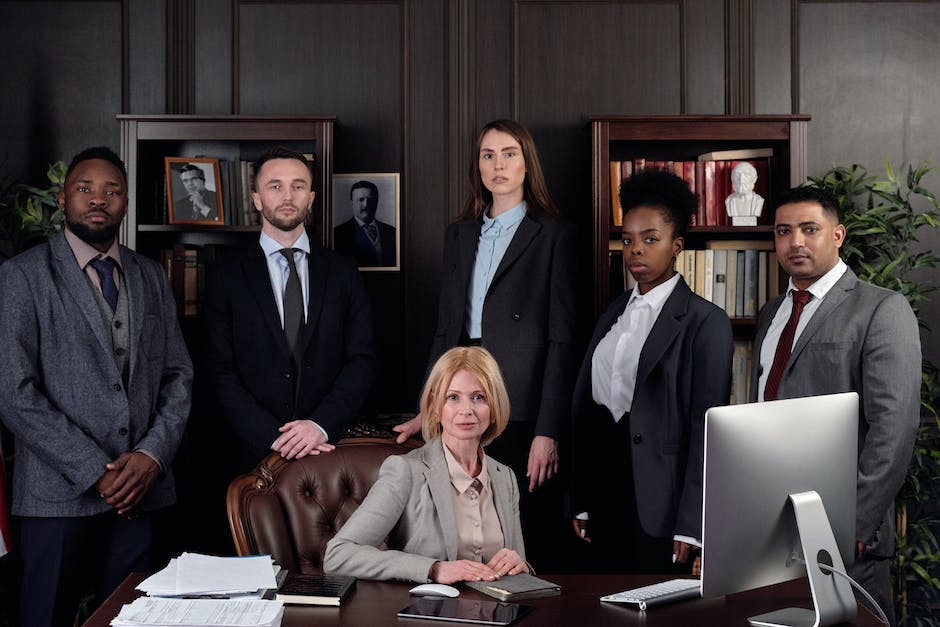 A defense attorney standing in a courtroom with a client, both appearing determined and confident.