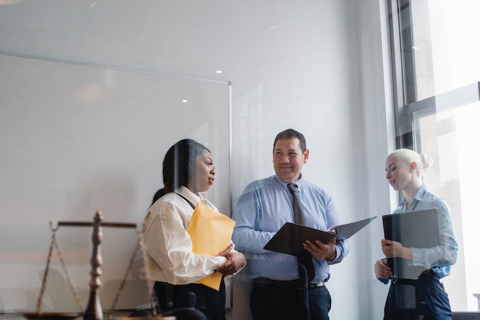 A group of attorneys discussing a case in a courtroom.