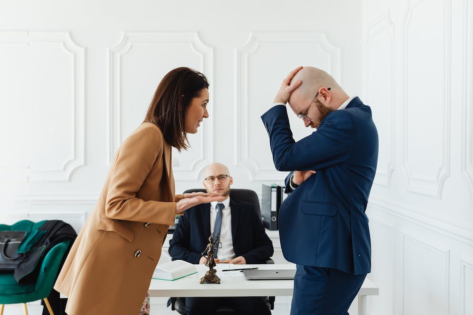 Image of a courtroom with a judge and lawyers discussing a plea bargain