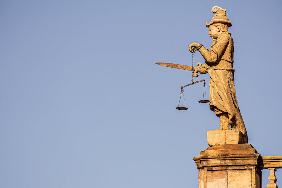 Probation Violation Defense - An image showing a person holding a scale representing the justice system, with one side depicting punishment and the other side depicting rehabilitation.